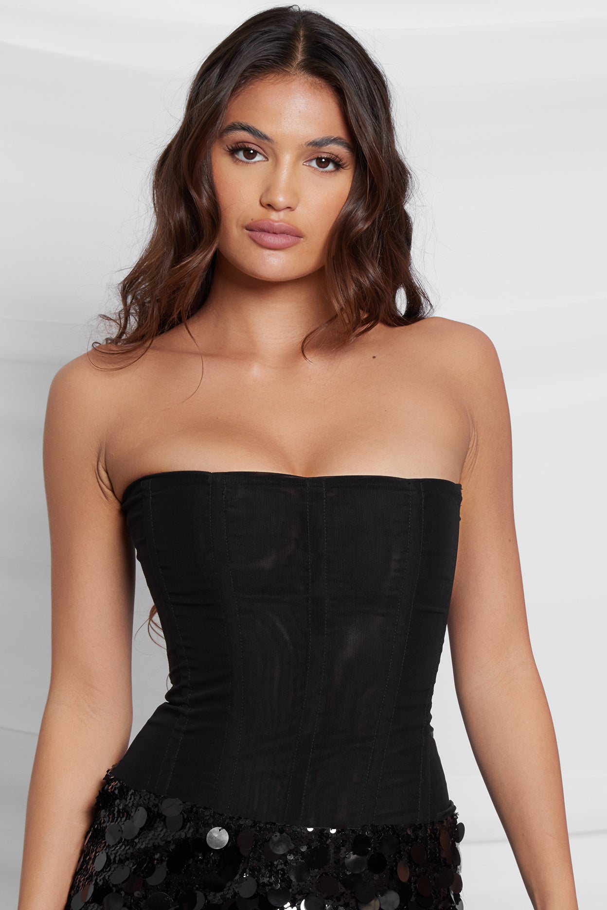Model wearing Muse Corset in Black, front view.