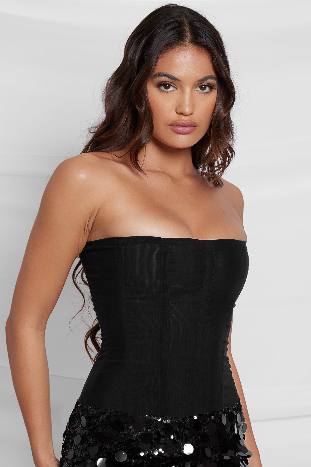 Model wearing Muse Corset in Black, side view.