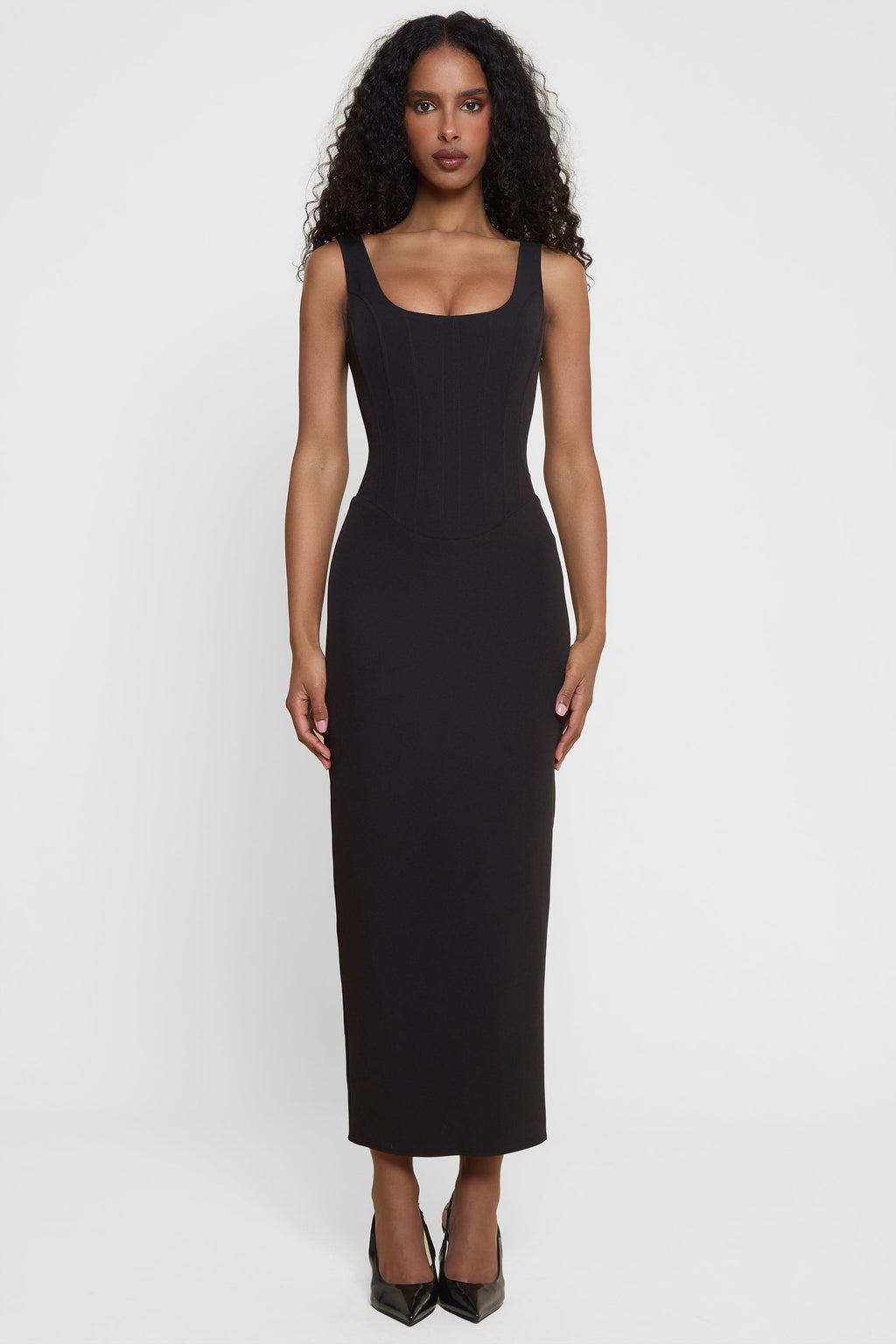 Model wearing Sancia Corset Midi Dress in Black, front view.