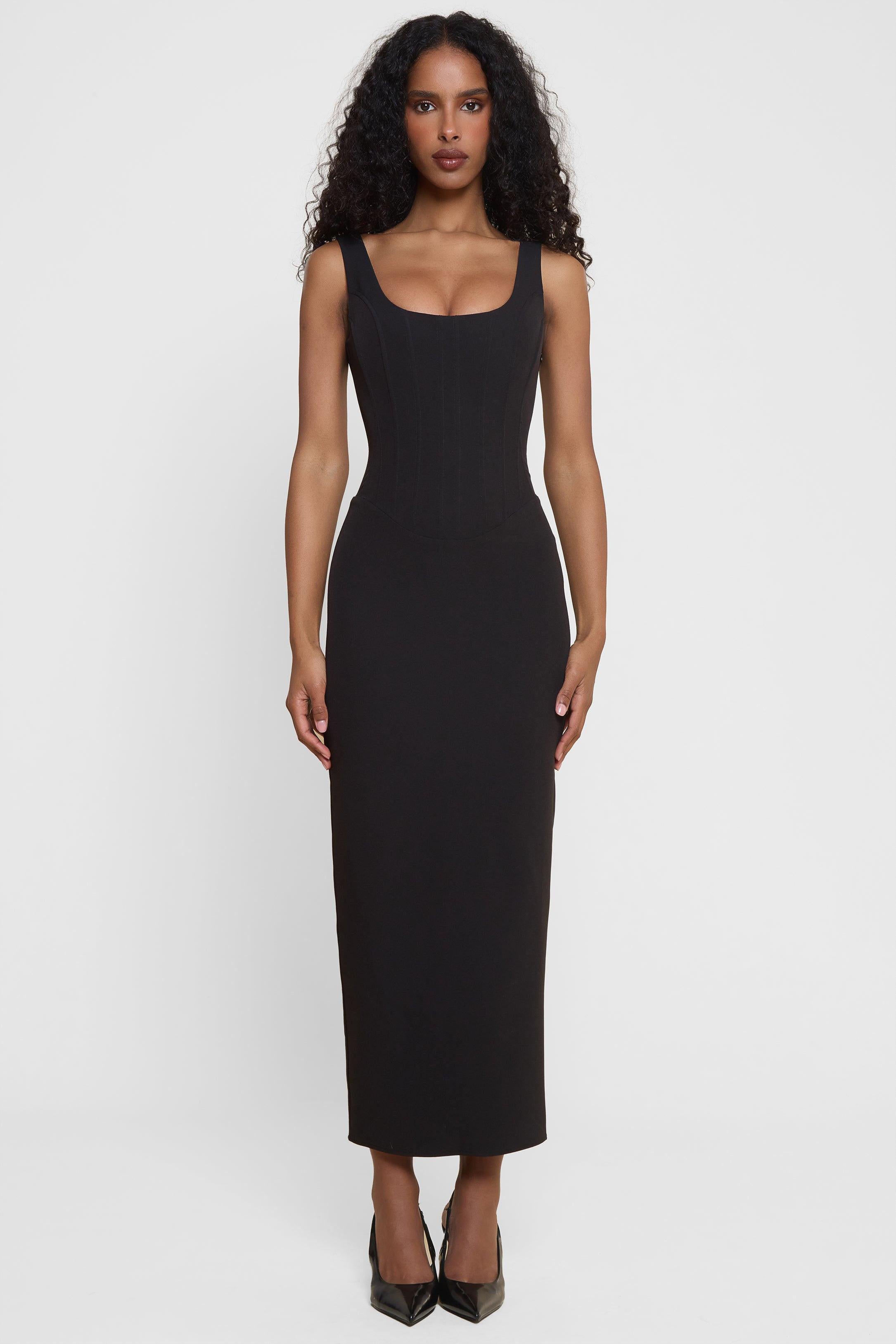 Model wearing Sancia Corset Midi Dress in Black, front view.