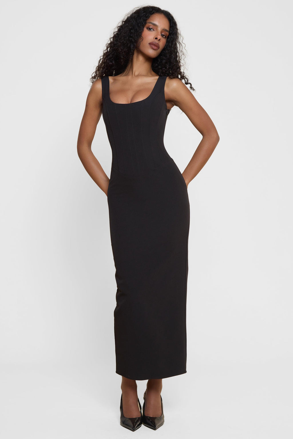 Model wearing Sancia Corset Midi Dress in Black, front view.