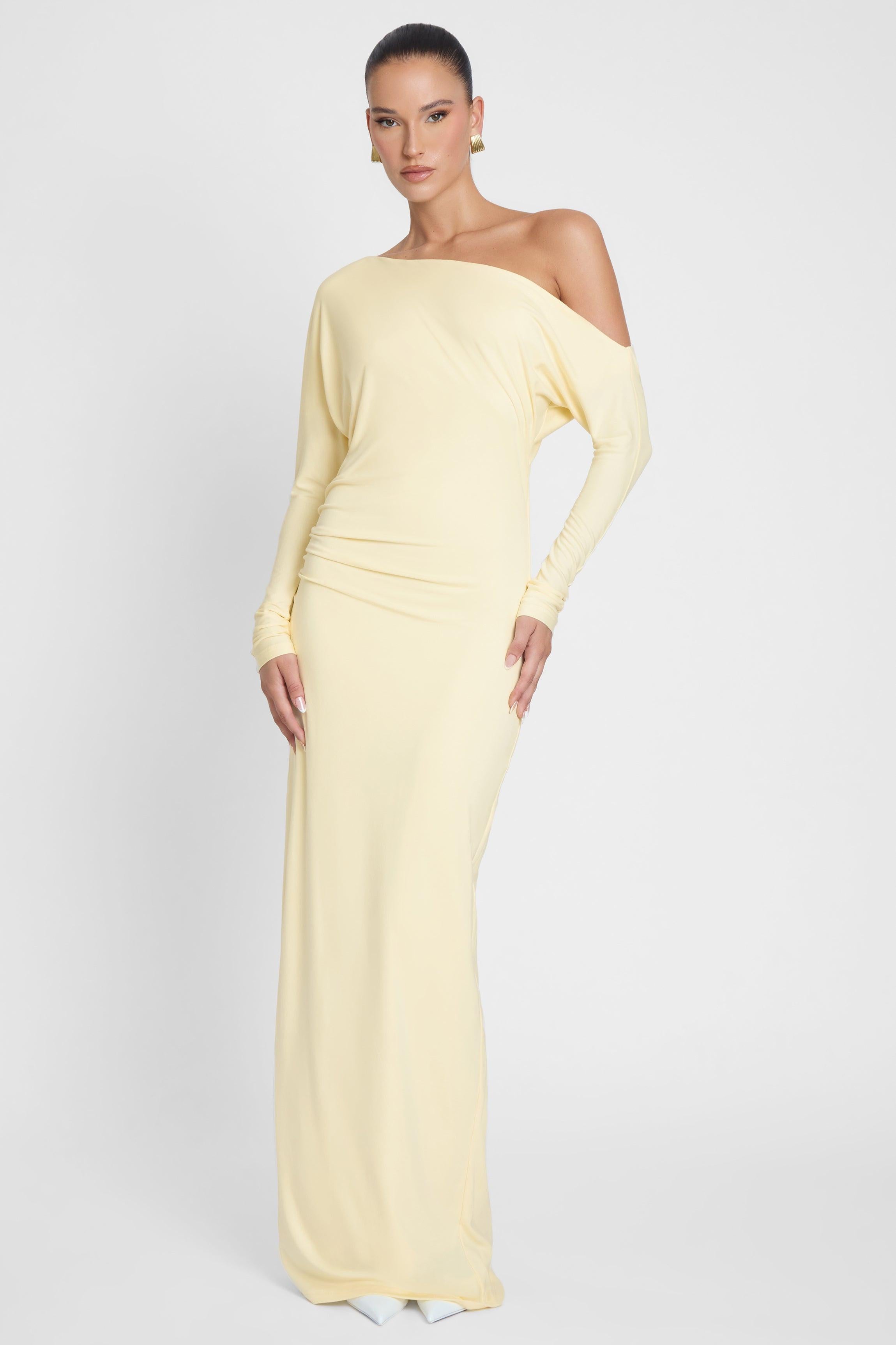 Model is wearing Sola Slouchy Jersey Maxi Dress Yellow, front view.