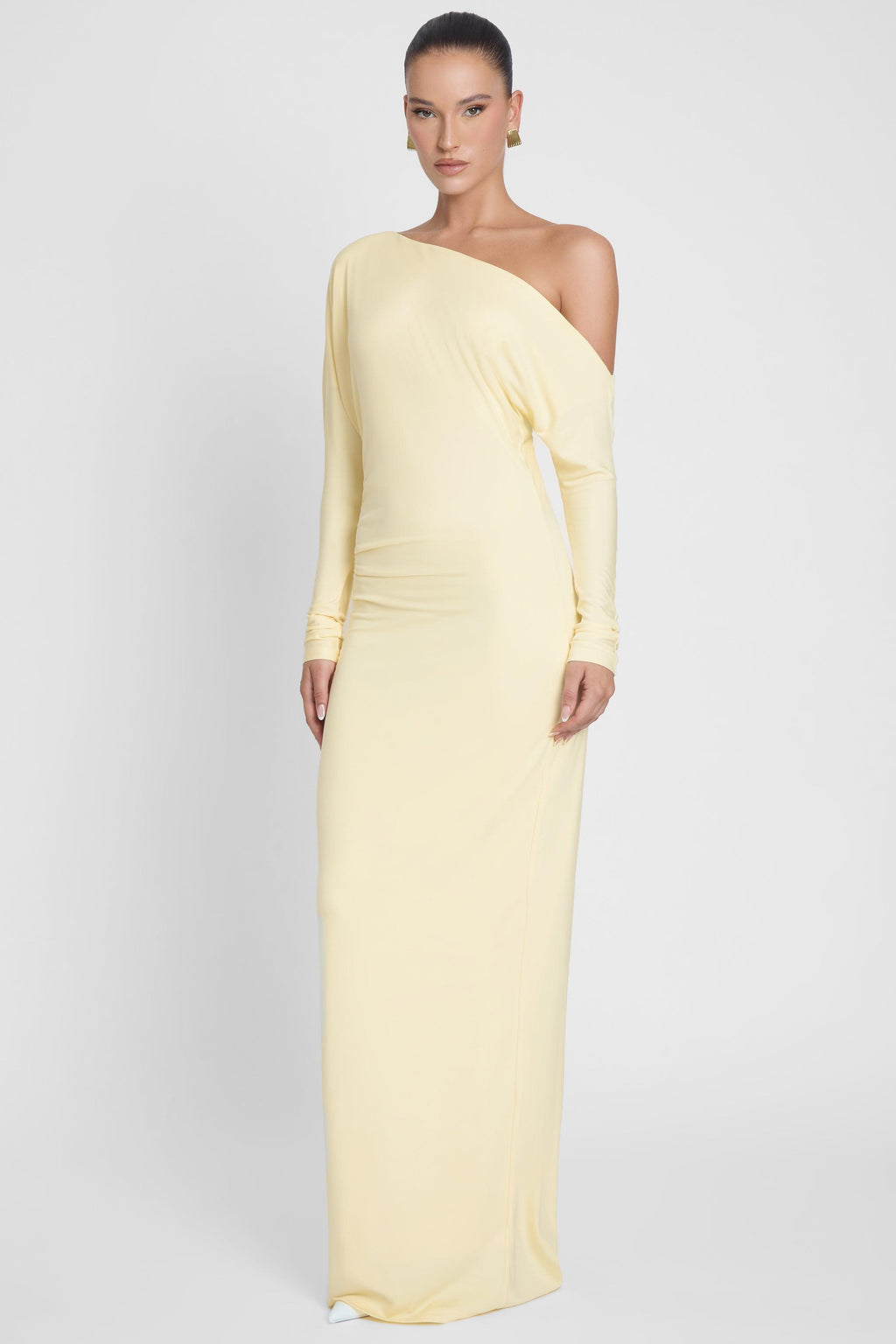 Model is wearing Sola Slouchy Jersey Maxi Dress Yellow, front view.